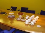 Boardroom table, set up for tea and cake