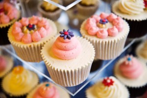 Pink swirl cupcake with rich purple flower
