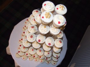 Brightly coloured flowers on wedding cupcakes